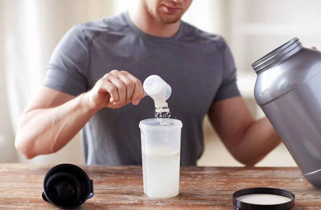 Man scooping Whey Protein Powder